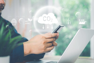 CO2, Carbon footprint concept. Man hand holding carbon reduction icon. Net zero and carbon neutral, Carbon emissions, CO2 neutrality, Sustainable energy, Climate change, Global warming, Greenhouse gas