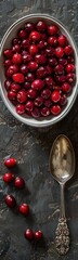 Bowl of cranberries and a spoon on a table, Food background
