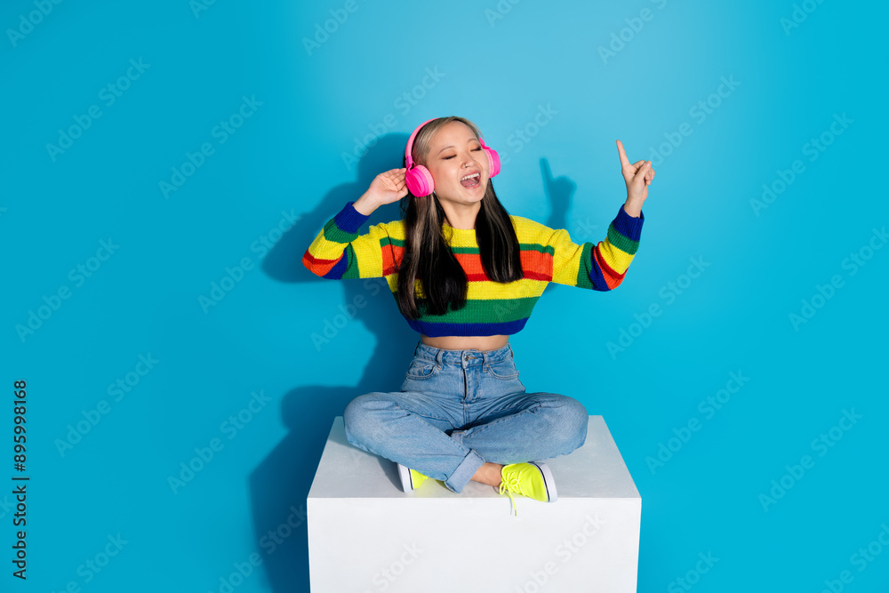 Wall mural full body photo of attractive young woman sit cube headphones sing dressed stylish striped clothes i