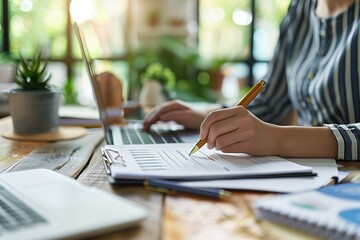 Close-up image of businesswoman working on laptop while sitting at her working place