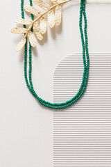 A necklace of green bead on a white background