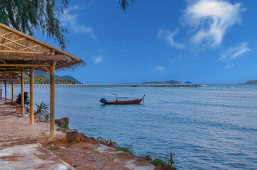 Colourful Skies Sunset over Rawai Beach in Phuket island Thailand. Lovely turquoise blue waters, lush green mountains colourful skies and beautiful views of long tail Boats