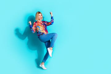 Full size photo of overjoyed girl with bob hairstyle dressed print shirt raising fists up win bet...