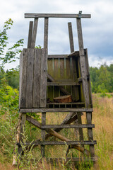 wooden hunting structure with a ladder and a bench