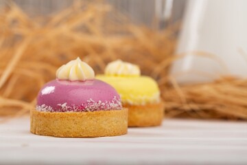 Cute sweet delicious cupcake on desk on pastel background