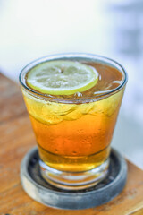 A glass of iced lemon tea on the table