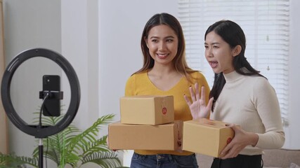 Two women unbox packages for online review in a bright, cheerful setting with professional lighting. Ideal for ecommerce, online business, and influencer marketing