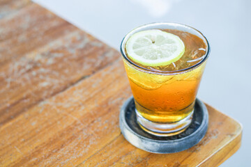 A glass of iced lemon tea on the table