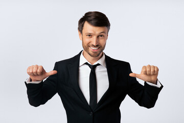 Confidence. Businessman Pointing Thumbs At Himself Over White Background In Studio. Isolated
