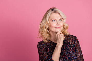 Portrait of nice aged lady look empty space wear dress isolated on pink color background