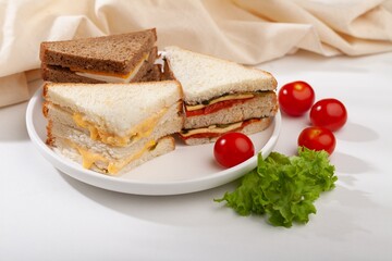 Fresh tasty sandwiches with vegetable on wooden chopping board