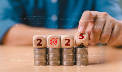 New Year 2025, budget plan concept. Businessman hand-flipped wooden block cube from end 2024 to...
