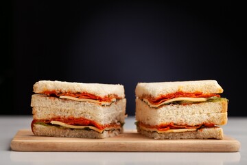 Grilled tasty cheese sandwich with fish on the desk