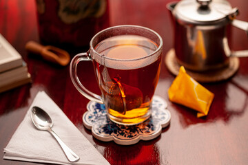Hot infusion of relaxing herbs in a transparent cup.