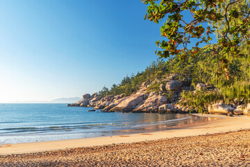 Picturesque golden sandy Alma Beach with granite boulders and turquoise water on Magnetic Island, Queensland, Australia. The island is a holiday destination 8 km offshore of Townsville.