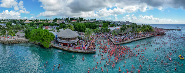 Aerial view of festive crowd celebrating New Year's Dive at Jan Thiel Bay, Willemstad, Curacao.