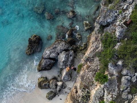 Aerial view of rocky coast with two persons by the ocean, Westpunt, Curacao.