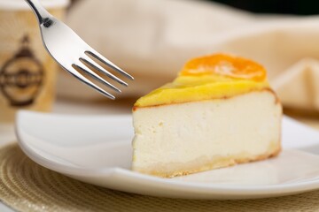 Delicious orange cheesecake with cream on plate