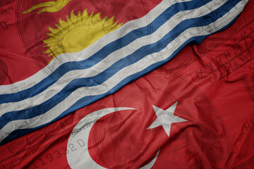 waving colorful flag of Kiribati and national flag of turkey on the dollar money background. finance concept.