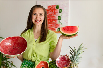 girl holding a homemade ceramic plate like a watermelon