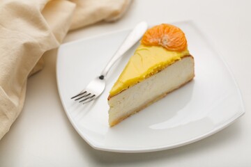 Delicious orange cheesecake with cream on plate