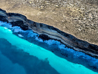 Aerial view of dramatic rocky coast with turquoise water at Baxter Cliffs, Great Australian Bight, Australia.