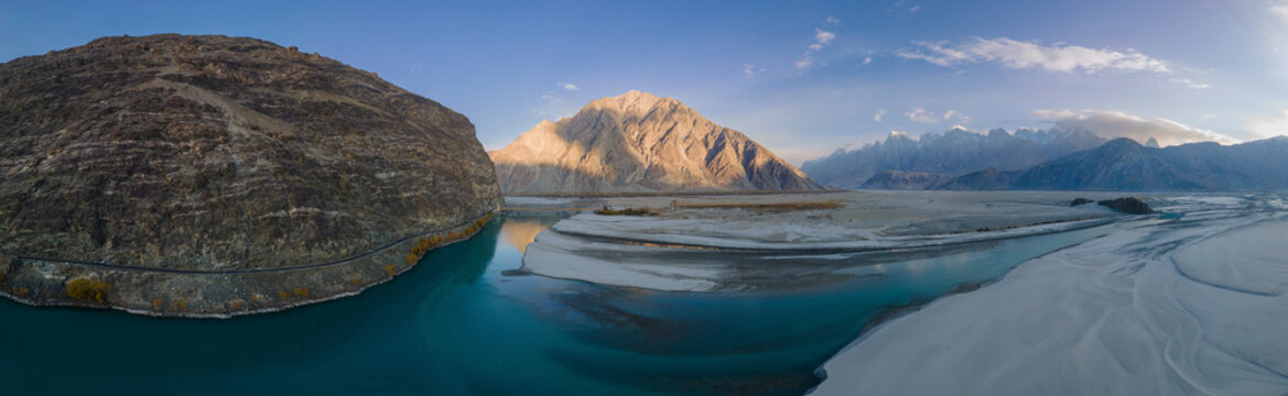 Aerial view of serene Saling Valley Khaplu with majestic mountains and tranquil river, Gilgit-Baltistan, Pakistan.