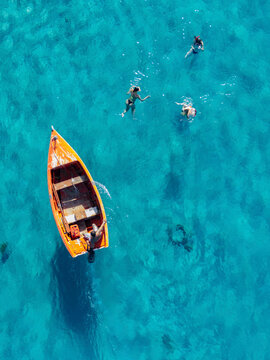 Aerial view of vibrant Caribbean sea with boats and people, Westpunt, Curacao.