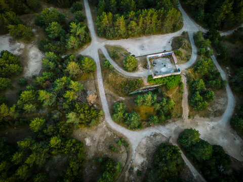 Aerial view of abandoned building in forest with road, Leba, Pomeranian Voivodeship, Poland.