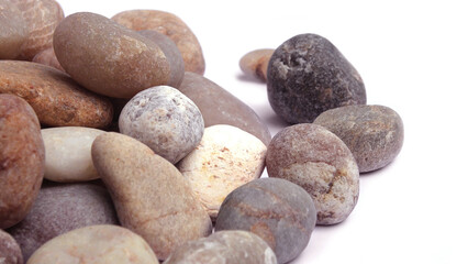 Pebbles piled on white background