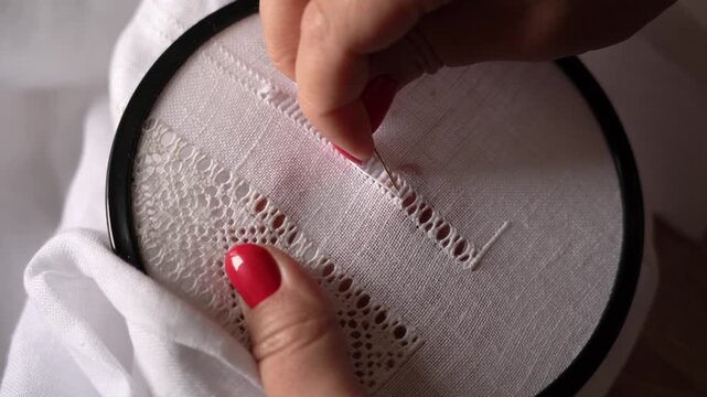 Embroidery Stitches for a Lace Design on White Fabric. Process of creating traditional Ukrainian embroidery