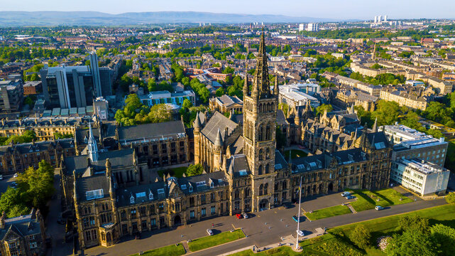 Aerial view of University of Glasgow campus with historic buildings, greenery, and towers, Glasgow, Scotland.