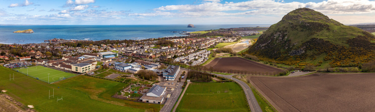 Aerial view of North Berwick Law overlooking town, coast, and sea, Scotland.