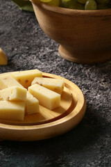 appetizer cheese with grapes and a glass of wine