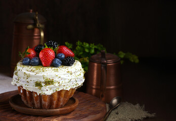 cupcake with frosting and fresh berries