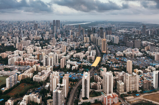 Aerial view of urban landscape with skyscrapers and busy roads, Mumbai, India.