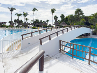 Swimming pool of a luxury resort hotel complex in the Caribbean, an ideal all-inclusive summer vacation spot for tourists looking for a relaxing lifestyle.