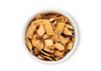 Bowl with sweet dried organic coconut pieces isolated on white background.Top view.
