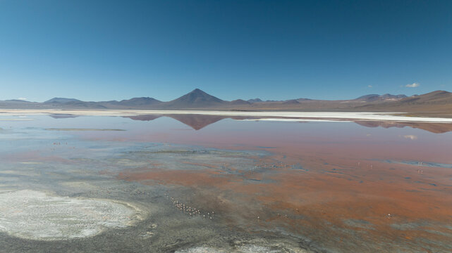 Aerial view of Laguna Colorada with mountainous desert landscape, San Pablo, Potosi, Bolivia.