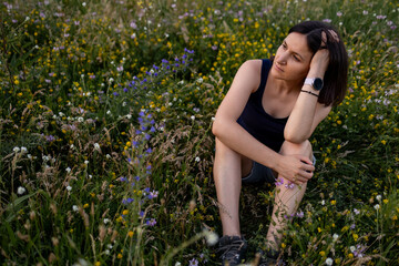 A young dreamy girl is sitting in nature.