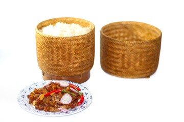 Food of Thailand with pork fried and sticky rice serving with chili and onions sliced put on white background with isolated concept.