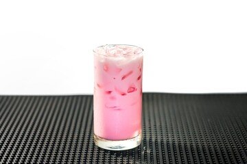 Pictures of special menu with iced pink milk and served on bar mat.sweet and good taste with concept beverage style.