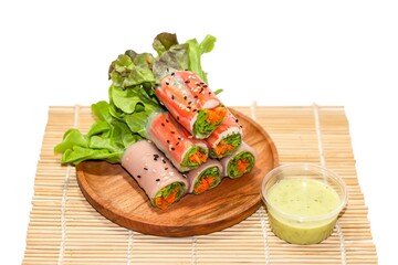 Vegetables salad noodle rolls serving on bamboo mat with isolated food organic concept.