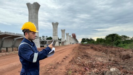  Engineer working at construction site try to inspect the project with determine and hard work.