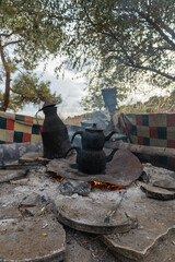 Camping on the Mediterranean coast with tea over a campfire