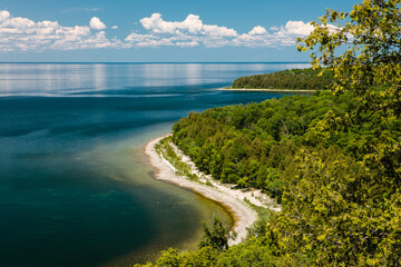 Overlooking Tennison Bay within Peninsula State Park, Fish Creek, Door County, Wisconsin in early June, as the distant clouds reflect off the calm Green Bay waters.