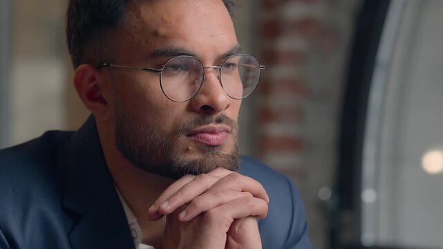 Arabian Indian man thoughtful pensive serious business guy male thinking puzzled businessman office think ponder idea question problem solution decide consider dream doubt close up portrait indoors
