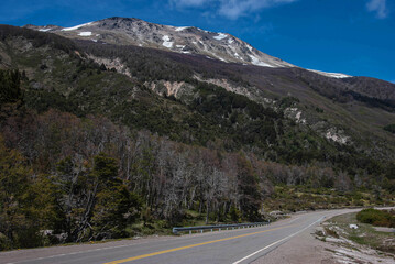 mountains with signs of snow at the peak, vegetation and highway in Patagonia