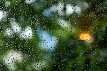 Blurred background of wet window glass with raindrops on it
