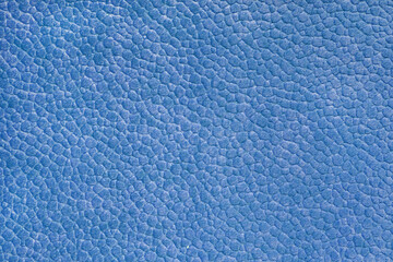 Velours blue fabric with with embossed pattern like leather structure texture close up, macro